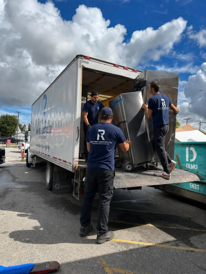Right Way Logistics crew carefully loading appliances onto the moving truck